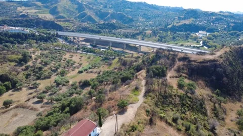 Aerial wide angle view of a chapel on a hill overlooking a highway Stock Footage 344105096