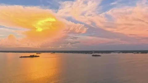 Aerial Wide Angle View of Dramatic Golden Sunset Clouds over St. Joseph Sound Foto stock