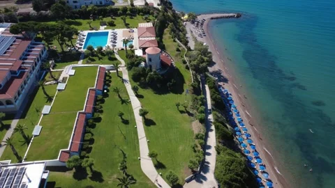 Aerial wide angle view of extensive hilltop hotels and beach in Greece Stock Footage 343940890