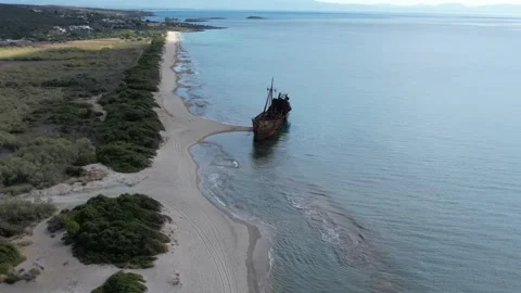 Aerial wide angle view of lonely shipwreck on deserted sandy coastline Stock Footage 343944401