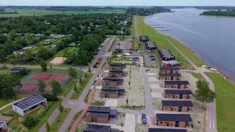 Aerial wide angle view of a modern lakeside holiday resort with elegant Stock Footage 339632863