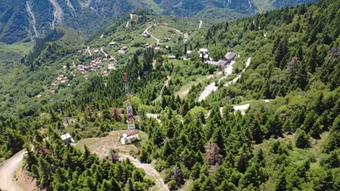 Aerial wide angle view of mountain village and telecom signal tower Stock Footage 343947975