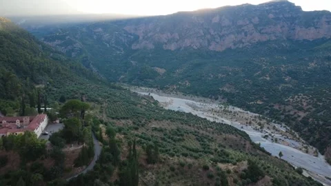 Aerial wide angle view of a mountain valley with river and monastery Stock Footage 343962621