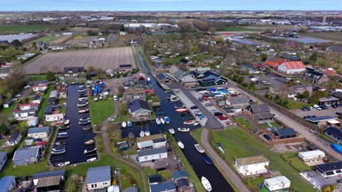 Aerial wide angle view over a coastal holiday village park with narrow marine Stock Footage 339222380