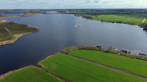 Aerial wide angle view over a large blue lake with sailing boats and yachts. Stock Footage 339224477