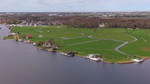 Aerial wide angle view over modern waterfront villa houses and floating houses Stock Footage 339225673