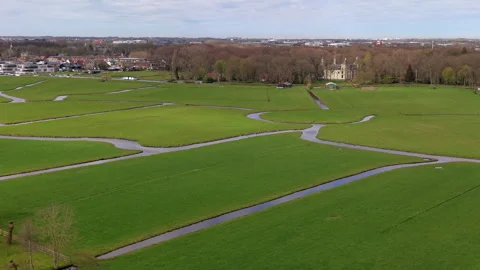Aerial wide angle view over a geometric network of winding drainage canals Stock Footage 339225705