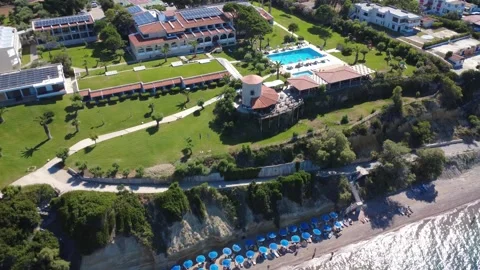 Aerial wide angle view of premium hilltop hotels and blue sea in Greece Stock Footage 343940820