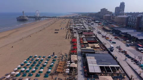 Aerial wide angle view of Scheveningen beach with rows of umbrellas Stock Footage 339631519