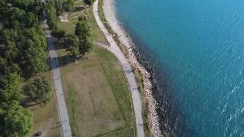 Aerial wide angle view of seaside park and turquoise Mediterranean sea Stock Footage 343948398