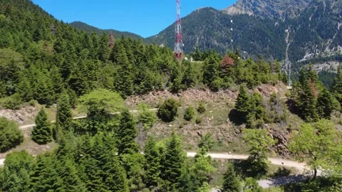 Aerial wide angle view of telecom tower on green mountain summit Stock Footage 343947100