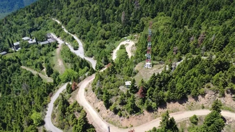 Aerial wide angle view of telecom tower road and remote village valley Stock Footage 343948024
