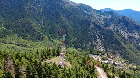 Aerial wide angle view of telecom tower above remote mountain village Stock Footage 343949177