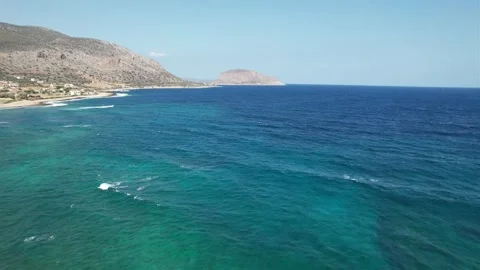 Aerial wide angle view of turquoise sea and distant island coastline Stock Footage 344304603