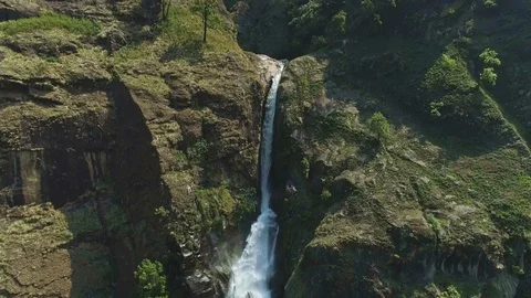 Aerial wide angle view on a waterfall falling to a deep river gorge Stock Footage 124678812
