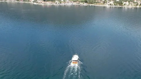 Aerial wide angle view of white tourist boat racing across blue ocean Stock Footage 343944160