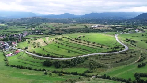 Aerial wide open View of Mountain empty road close to a Romania Village Stock Footage 194553353