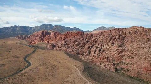 Aerial wide pullback view of colorful Calico sandstone cliffs in Red Rock Canyon Stock Footage 122915593