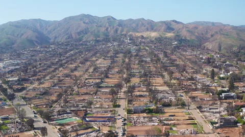 Aerial wide pullback view of Pacific Palisades Los Angeles post Forest Fire Stock Footage 308179424