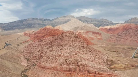 Aerial wide pullback view of Red Rock Canyon mountain range, peaks, and cliffs Stock Footage 121528882