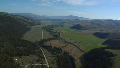 Aerial wide shot of green valley and forest Stock Footage