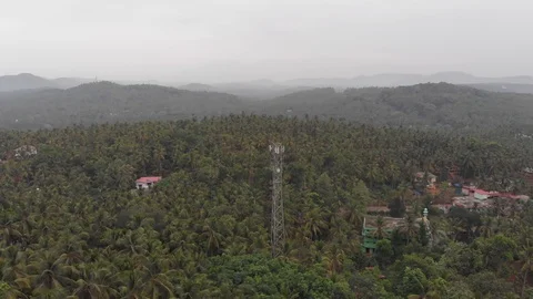 Aerial wide shot of telecommunications tower antenna in rain forest Stock Footage