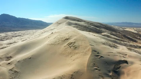 Aerial of Wind Blowing Sand Across Giant Sand Dunes Stock Footage 127005671