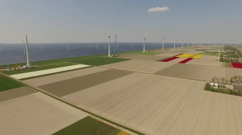 Aerial of a wind park in a typical landscape with the north sea in the Stock Footage 64204656