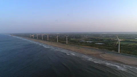 Aerial - Wind power plant lining the coast Stock Footage 89368749