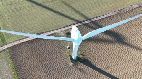 Aerial Wind Turbine Casting Shadow Across Agricultural Fields Stock-Footage 327974388