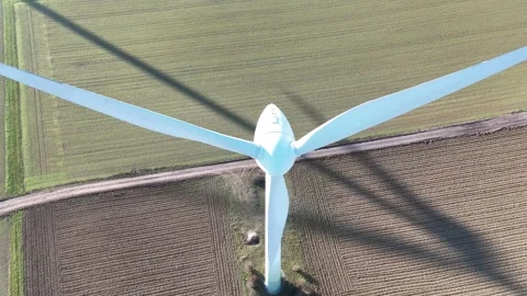 Aerial Wind Turbine Casting Shadow Across Agricultural Fields Stock-Footage 327974628