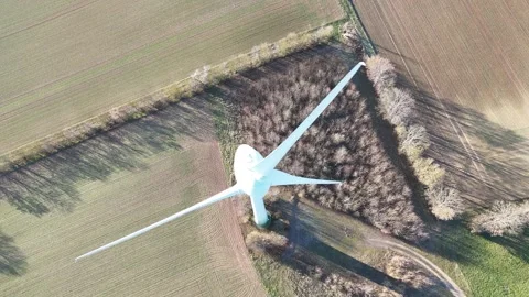 Aerial Wind Turbine Casting Shadow Across Agricultural Fields Video stock 327974662
