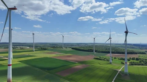 Aerial Wind Turbine Casting Shadow Across Agricultural Fields Video stock 327982844