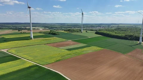Aerial Wind Turbine Casting Shadow Across Agricultural Fields Video stock 327982869