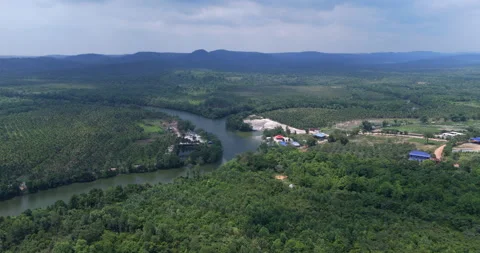 Aerial winding river, sand dredging site, palm plantations, and distant hills. Stock Footage 331447386