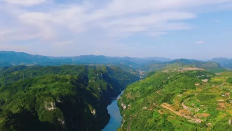 Aerial Winding River Through Lush Green Mountain Valley and Terraced Hillsides Stock Footage 342092273