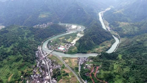 Aerial Winding River Through Lush Green Mountains and Rural Village Landscape 動画素材 342092366