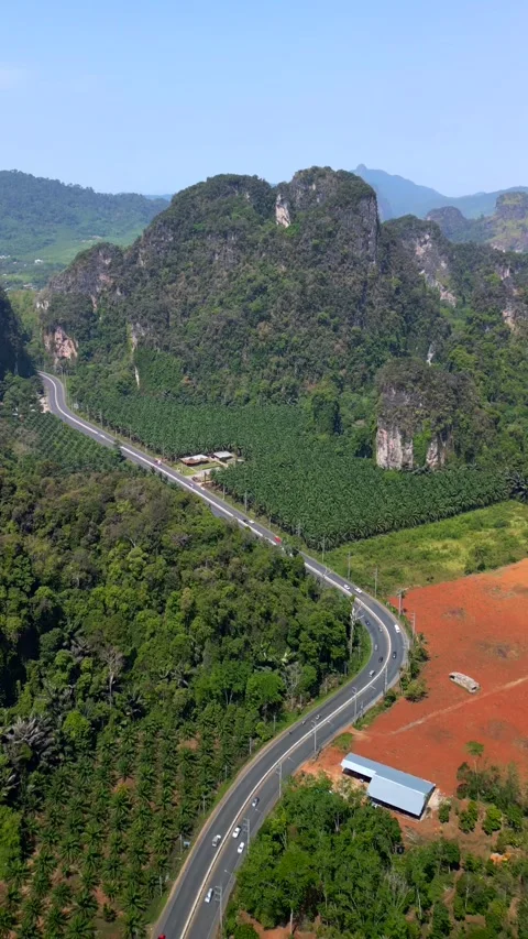 Aerial of winding road through dramatic limestone landscape of Krabi, Thailand 스톡 동영상 340839216