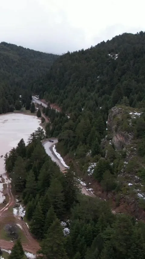 Aerial winding road through forest canyon with fog and mountain lake Stock Footage 343993045