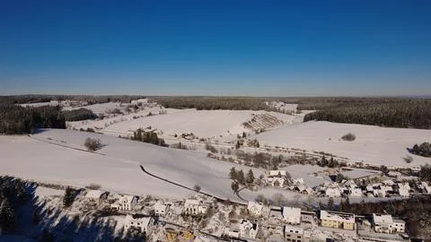 Aerial winter forest in the Black Forest with snow and rural landscape Stock Photos