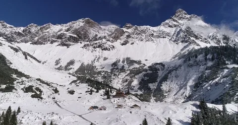 Aerial winter view of alps mountains and cabin hut in Austria. Drone rising up Stock Footage 80953963