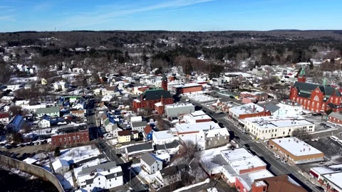 Aerial winter view of downtown Ware, Massachusetts, showing snow-covered Stock Footage 328649129