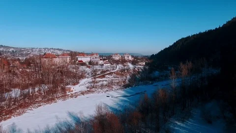 Aerial winter view high above rural village surrounded by pine tree forest 動画素材 71977810