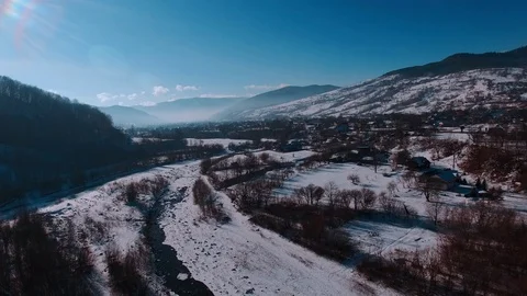 Aerial winter view high above rural village surrounded by pine tree forest 库存影片 71981687