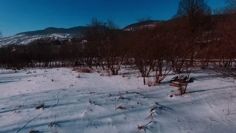 Aerial winter view high above rural village surrounded by pine tree forest Stock Footage 71982870