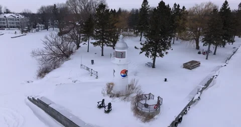 Aerial Winter View of a Lighthouse Surrounded by Snow Stock Footage 300687847