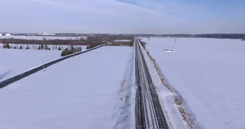 Aerial Winter View of a Passenger Train Traveling Through a Snow Landscape Stock Footage 300687804