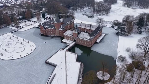 Aerial winter view of a red brick castle with towers and a partially frozen Stock Footage 329104267
