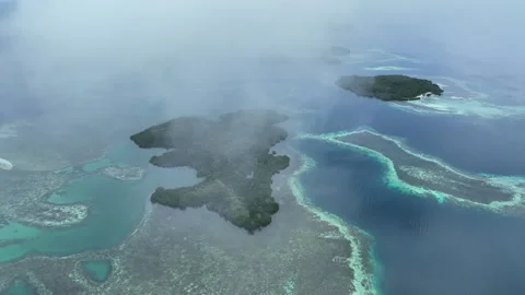 Aerial of Wispy Clouds Drifting Over Tropical Islands and Coral Reefs Stock Footage 310510902