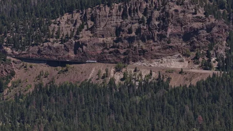 Aerial of Wolf Creek Pass traversing forested mountain slope in Mineral County Stock Footage 342747180